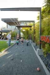 Bocce court with cantilevered steel arbor